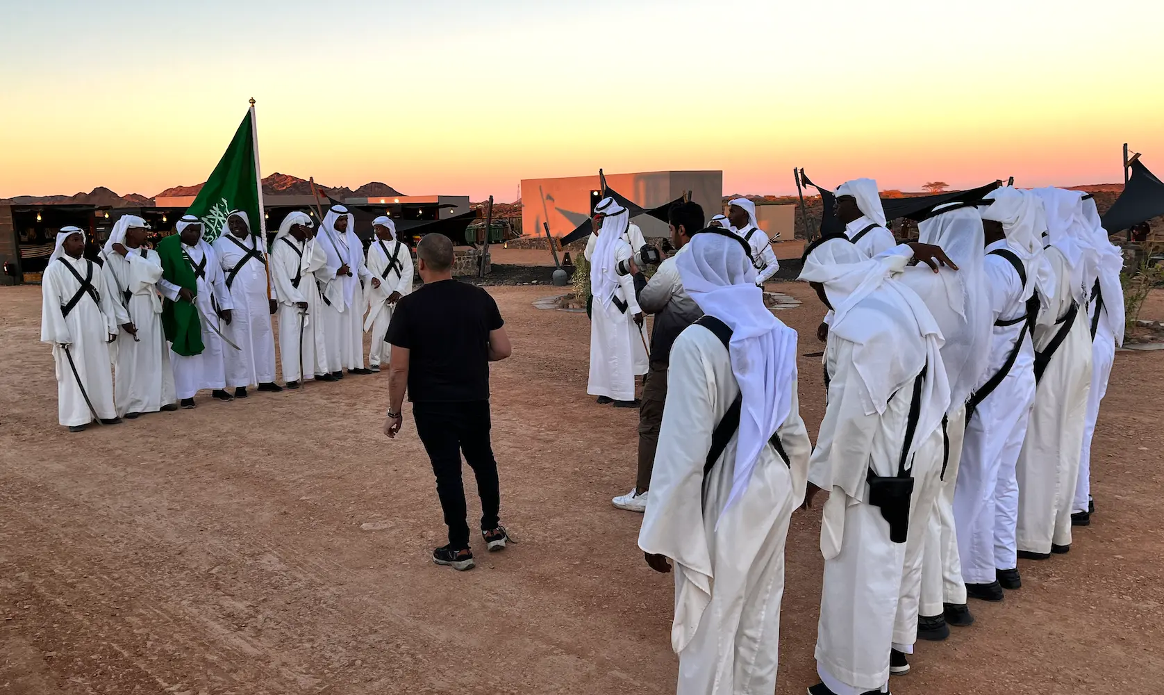 Traditional performers assembling with the Saudi flag before the event