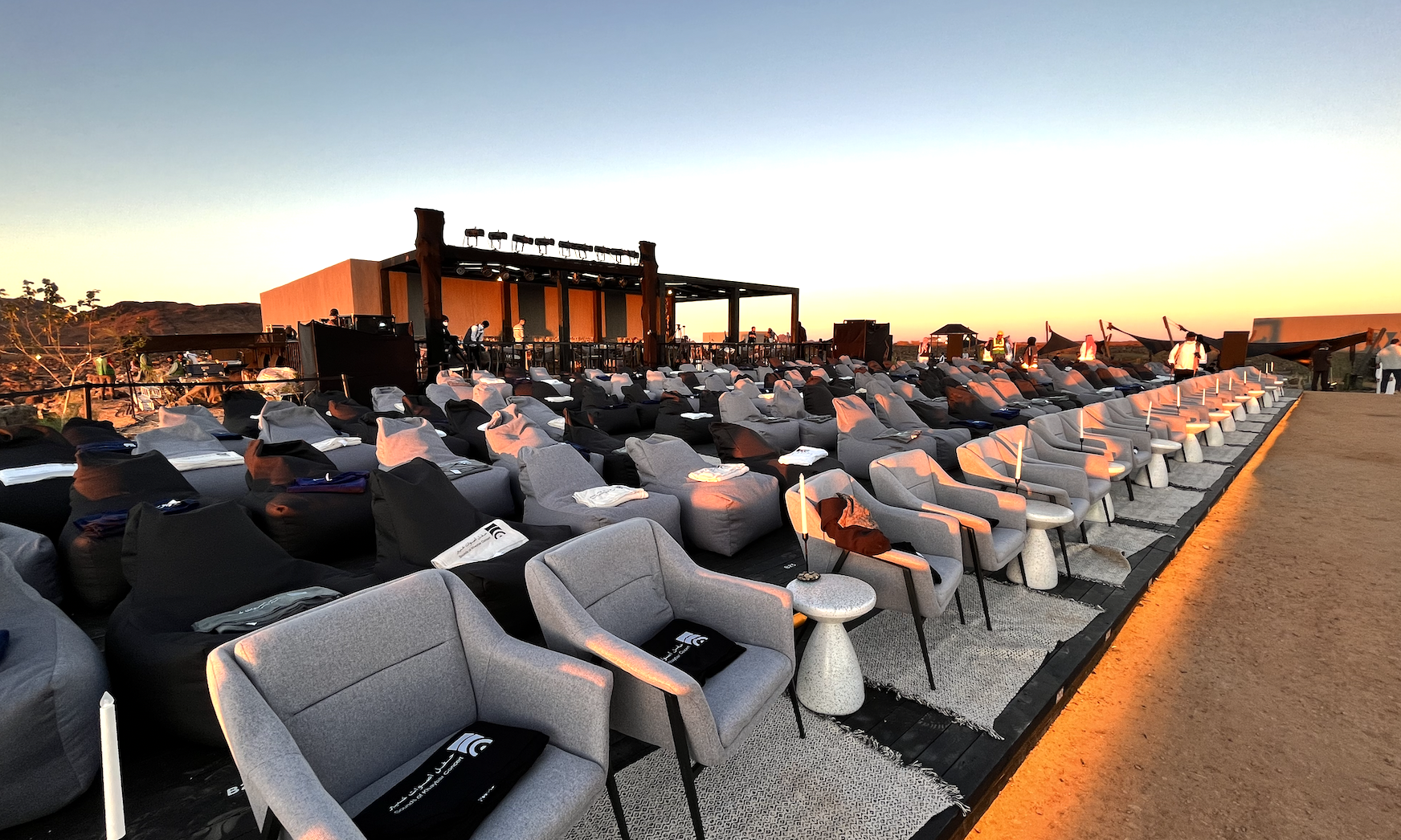 Audience seating prepared around the outdoor Sounds of Khaybar stage at sunset